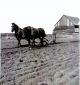 Johnson, George plowing behind the barn