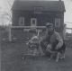 McLeod, George & Mary at the home where George grew up. The family lived there until Mary was 5.